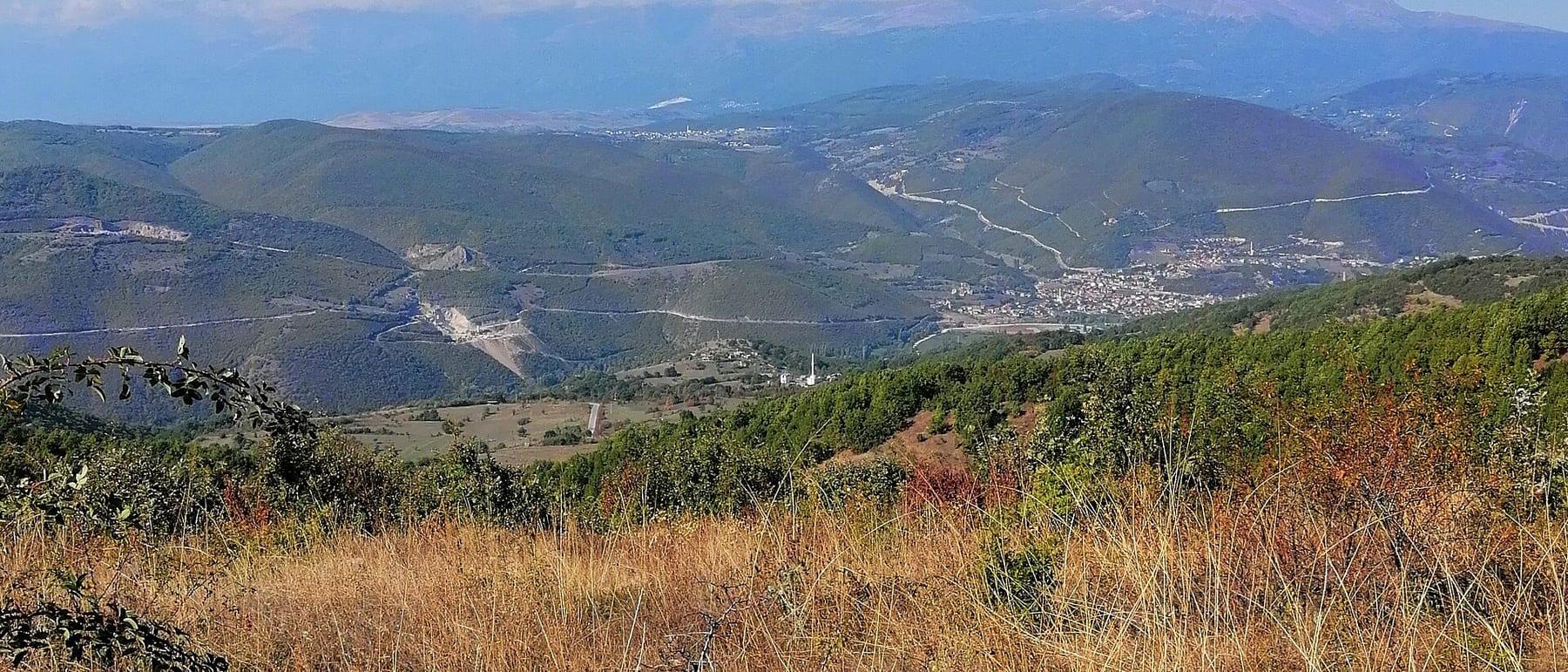 A mountain valley with a village in the middle, seen from above