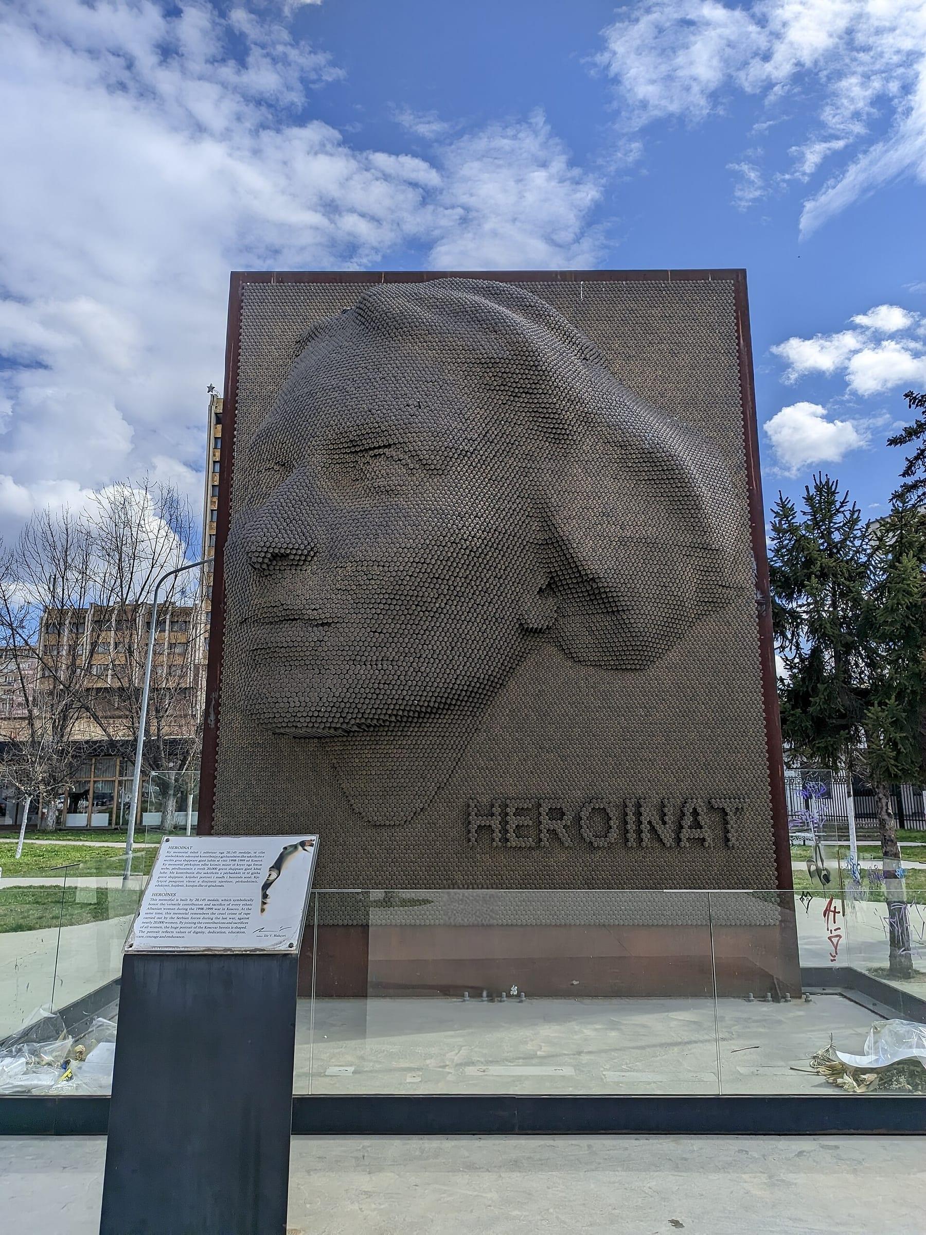 Frontal view of the memorial with its information plaque in front.