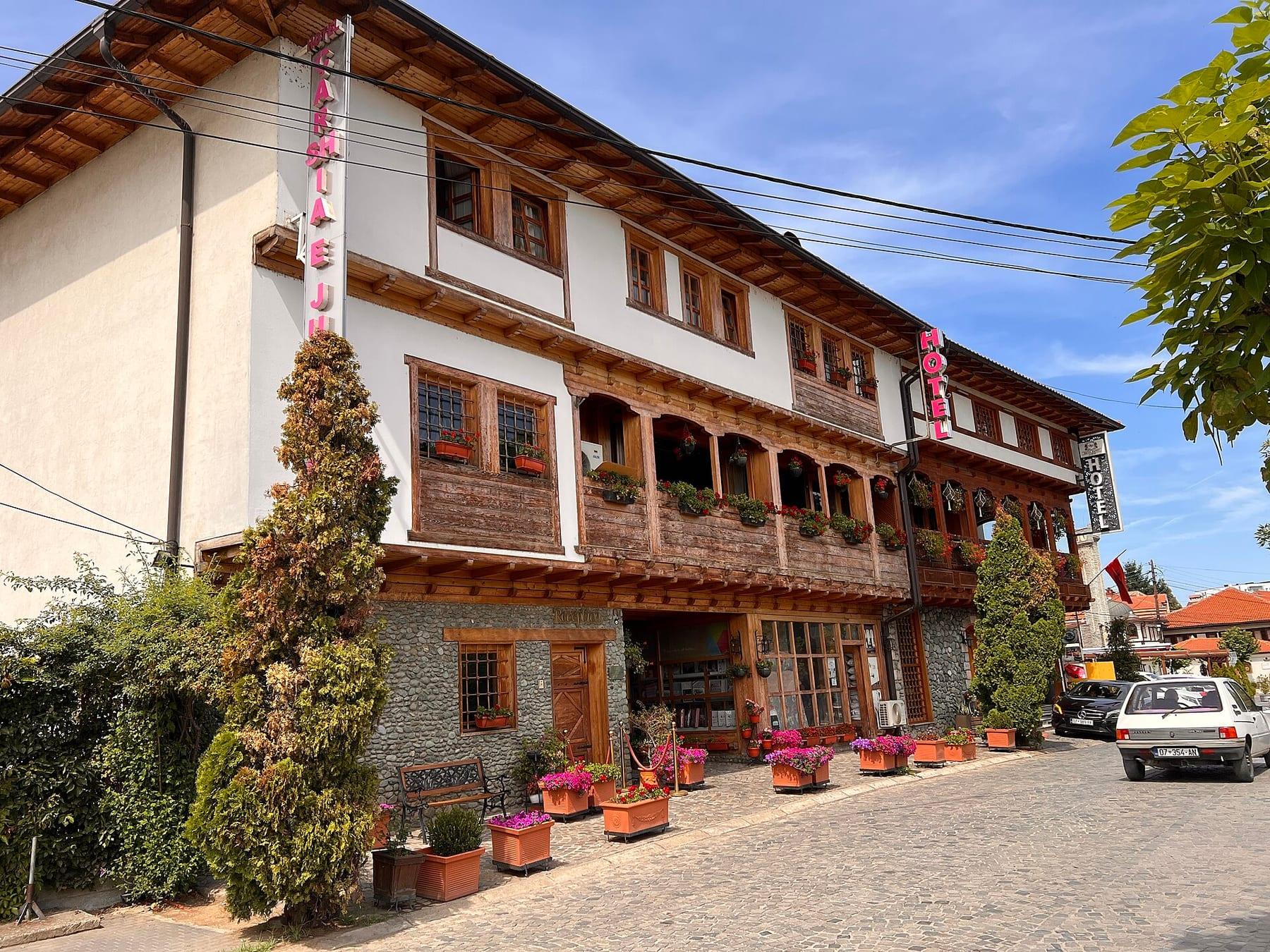 Traditional two-storey building with wooden balconies along a cobbled street.