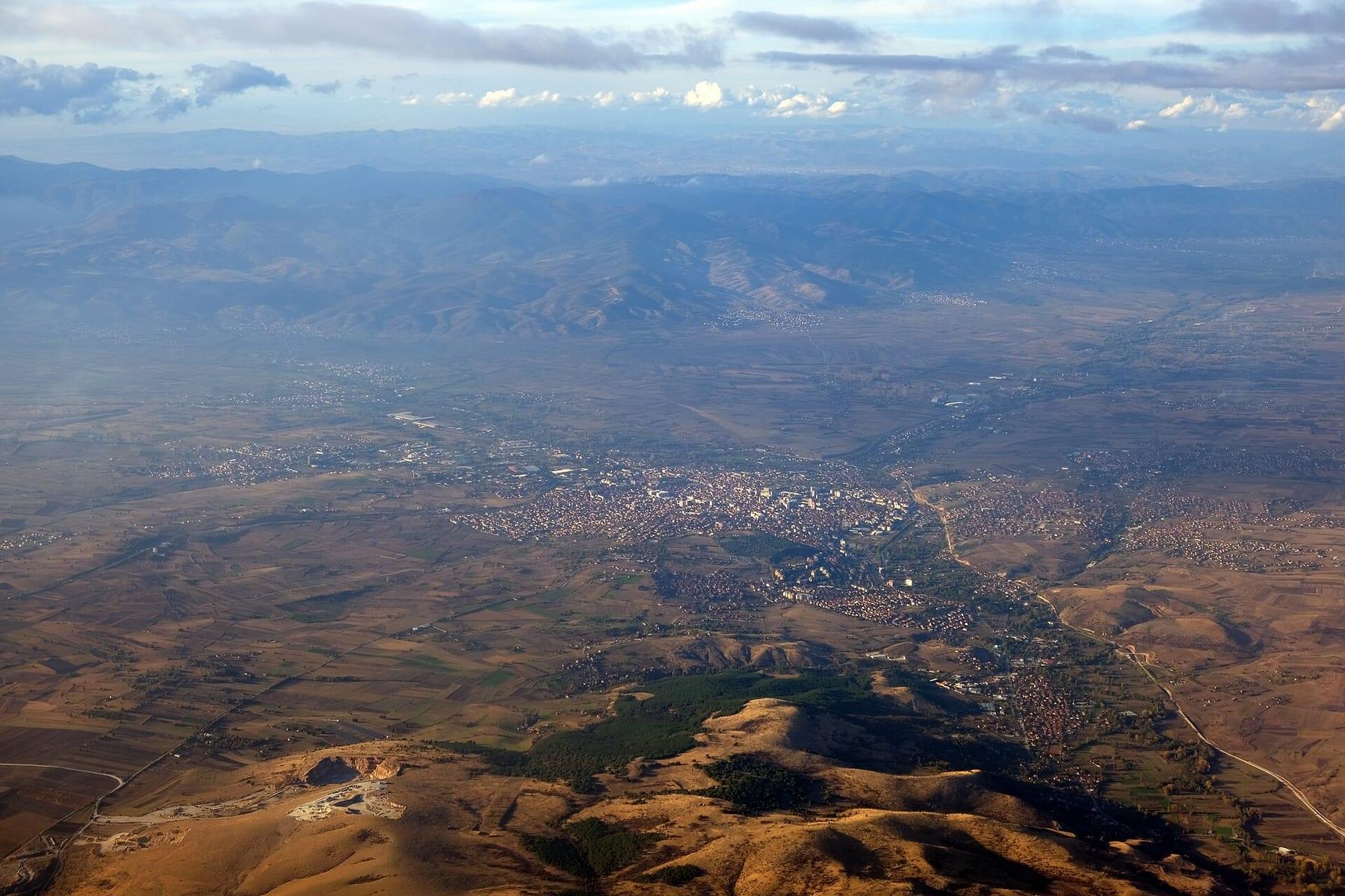 Aerial view of the city among dry hills.
