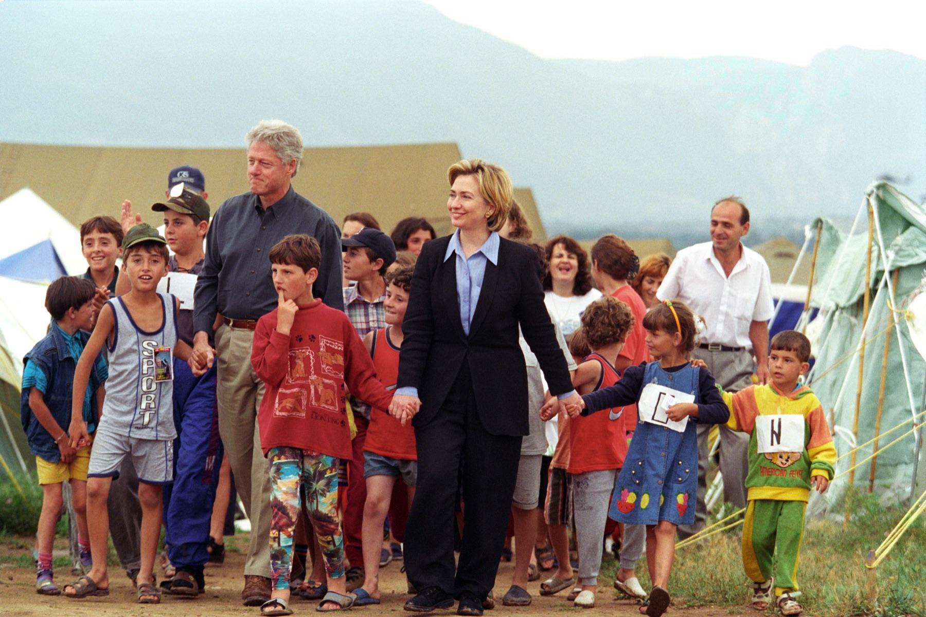 Official visitors among refugees in a tent camp